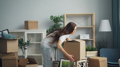 Sorting belongings into boxes before an elderly person's move